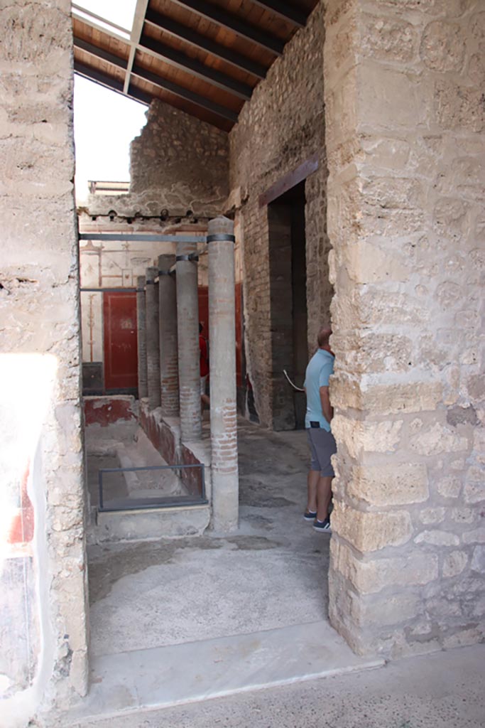 VI.15.1 Pompeii. October 2023.
Looking north to doorway into small yard with portico, from north portico of peristyle garden.
Photo courtesy of Klaus Heese.