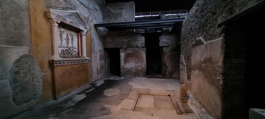 VI.15.1 Pompeii. January 2023. 
Looking north from doorway in atrium into “services area”, kitchen etc, with lararium, on left, and an impluvium, centre right.
Photo courtesy of Miriam Colomer.