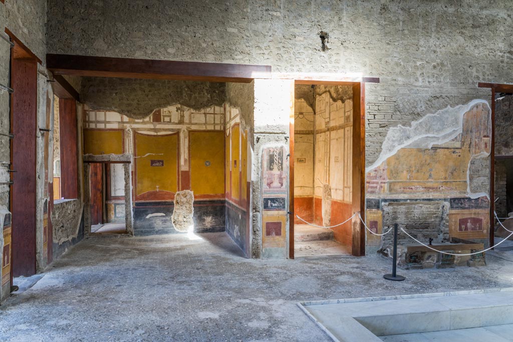 VI.15.1 Pompeii. March 2023. 
Looking north across west end of atrium from south ala h, towards north ala i, on left. Photo courtesy of Johannes Eber.
