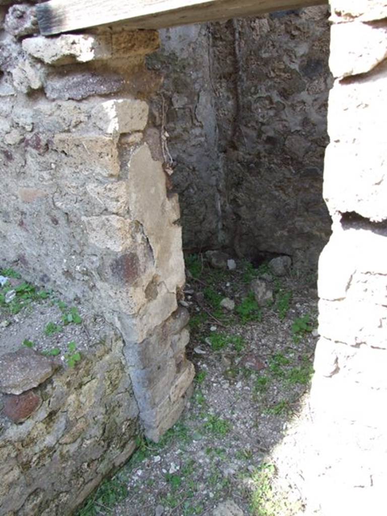 VI.15.5 Pompeii. March 2009. Room 2, north end of bench and doorway into latrine.