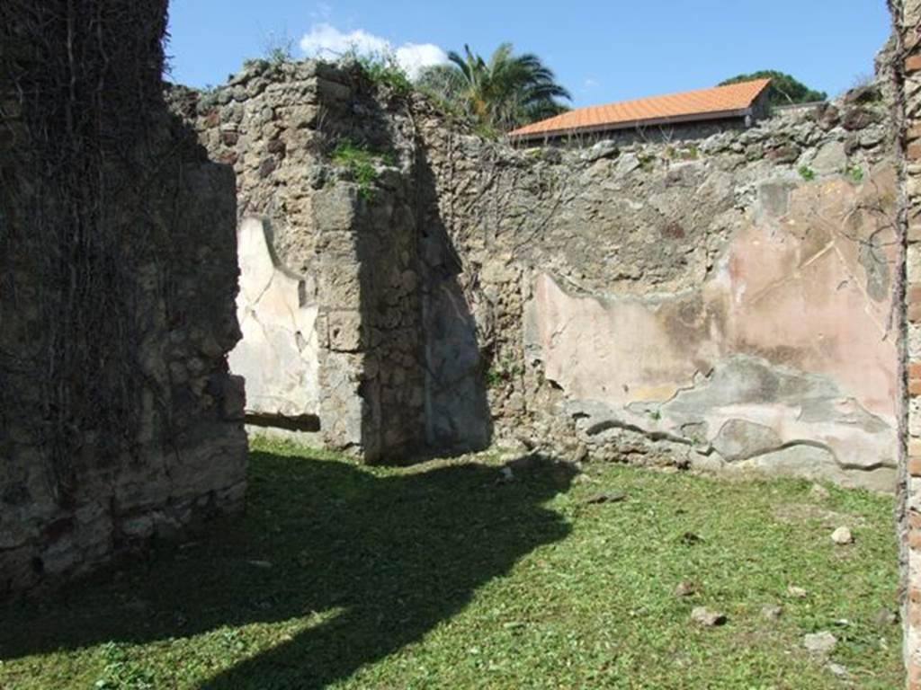 VI.15.5 Pompeii. March 2009. Room 6, ala on north side of atrium. Looking north-west with doorway into room 24.
According to NdS, both alae had a floor of opus signinum. This ala had walls decorated with red and yellow panels.