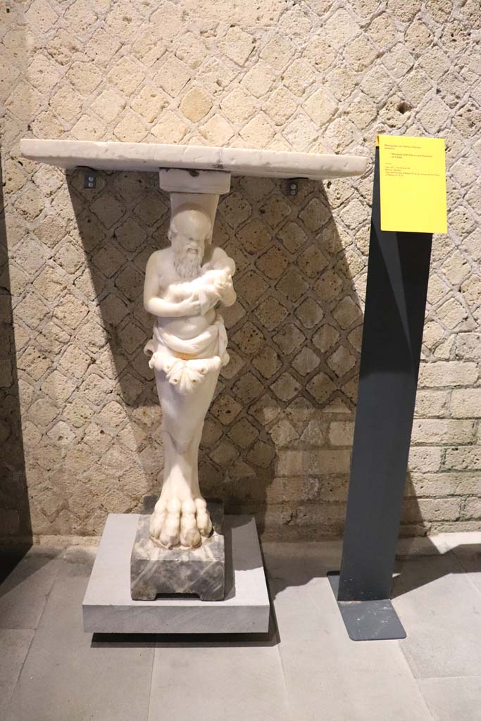 VI.15.8 Pompeii. February 2021. 
Marble monopodium, with Silenus and Dionysus as a baby, photographed in Antiquarium.
Photo courtesy of Fabien Bièvre-Perrin (CC BY-NC-SA).