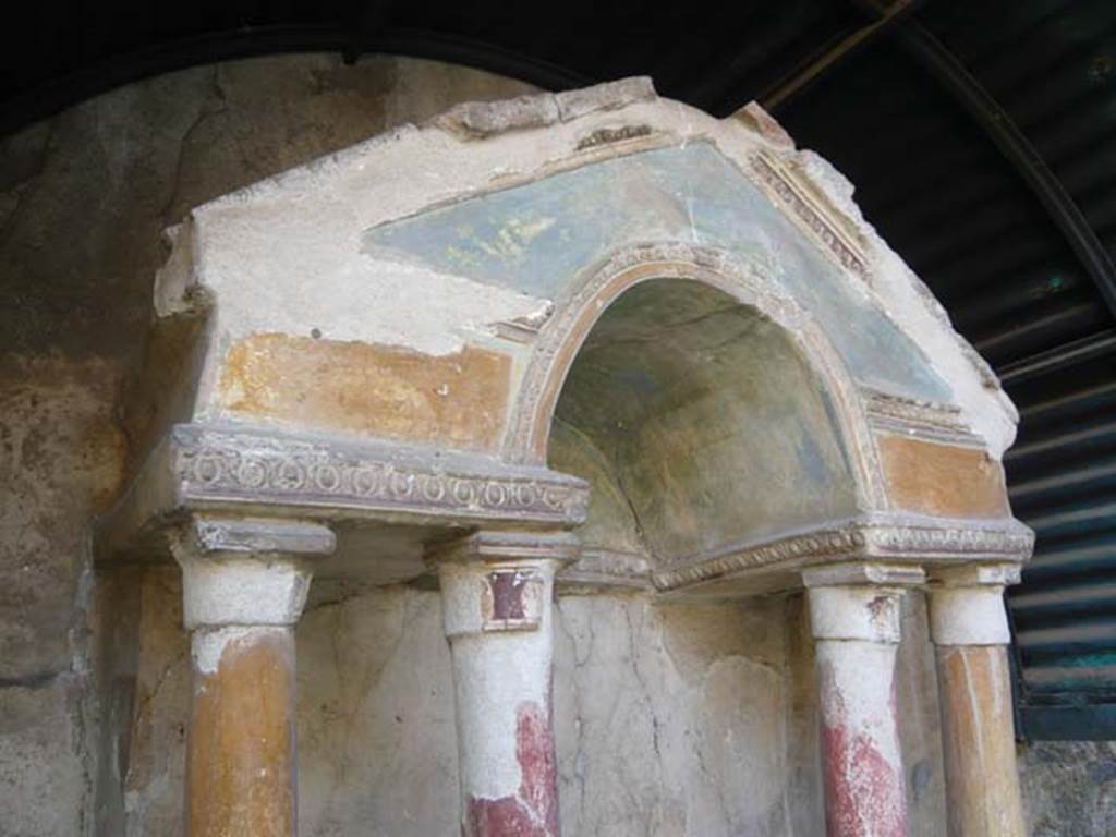 VI.15.8 Pompeii. May 2012.  Painted columns and pediment on household shrine in the garden. Photo courtesy of Buzz Ferebee.