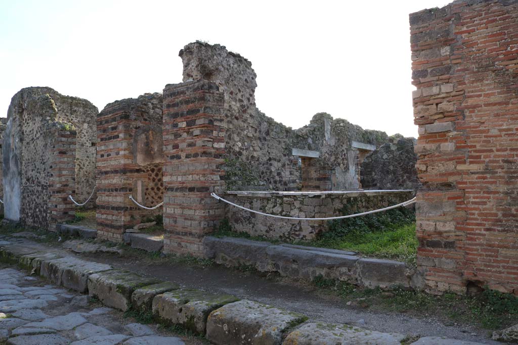VI.15.14 Pompeii, centre left. December 2018. 
Looking south-east towards entrances on west side of Vicolo dei Vettii. Photo courtesy of Aude Durand.
