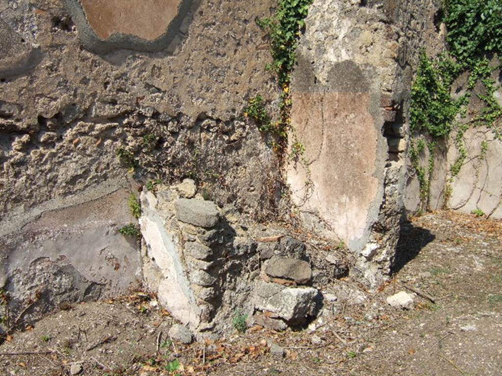 VI.15.21 Pompeii. September 2005. Remains of base of stairs to upper floor in atrium/yard.
According to NdS, in the middle of the atrium was an impluvium in which a terracotta dolium was buried up to the brim. Near the north wall was the staircase leading to an upper mezzanine. See Notizie degli Scavi, June 1897, (p.273)