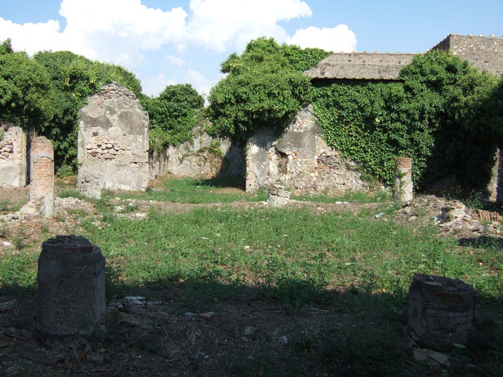 VI.15.23 Pompeii. September 2005. Looking east across peristyle.
According to Jashemski, the peristyle garden excavated in 1896-7 was enclosed on all four sides by a portico.
It was supported by eleven columns covered with rough plaster.
The columns were joined by a low masonry wall which had an entrance to the garden on the east side.
There was a puteal enclosed in the south wall between the last two columns at the east end.
Around the edges of the garden was a gutter.
There was a marble foot for a fountain basin or a table in the portico.
See Jashemski, W. F., 1993. The Gardens of Pompeii, Volume II: Appendices. New York: Caratzas. (p.158).