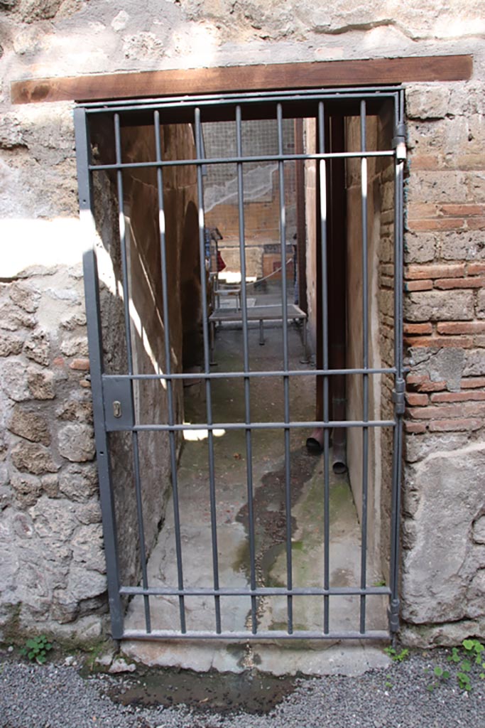 VI.15.27 Pompeii. October 2023. 
Looking north through doorway into corridor leading to atrium. Photo courtesy of Klaus Heese.