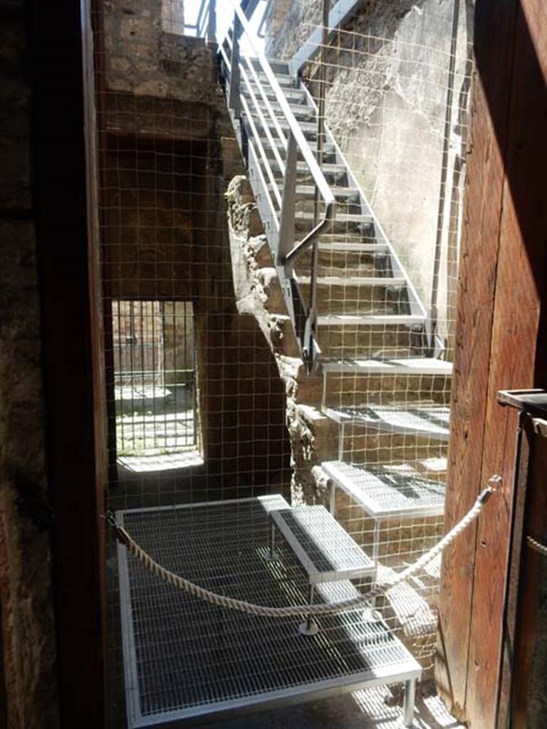 VI.15.27 Pompeii. May 2017.   
Looking south from atrium of VI.15.1, towards room with steps to upper floor and corridor leading to stable entrance at VI.15.27.
Photo courtesy of Buzz Ferebee.