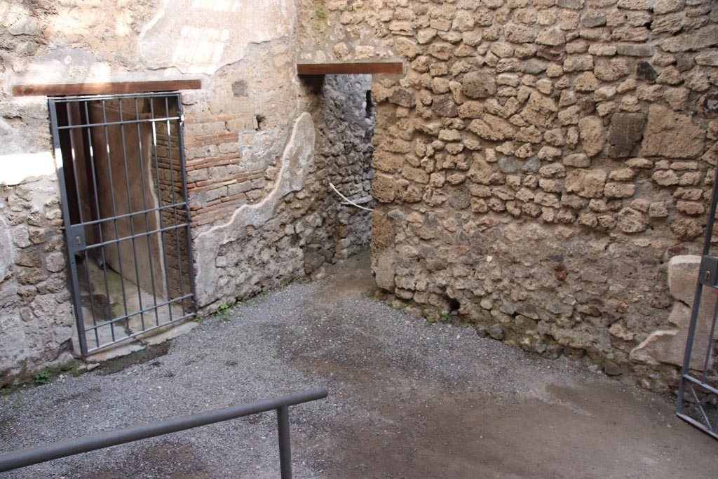 VI.15.27 Pompeii. October 2023. 
Looking north-east from steps towards corridor to atrium, on left, and doorway to stable, in centre. Photo courtesy of Klaus Heese.
