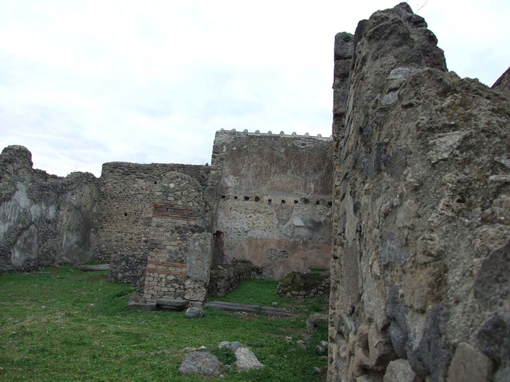 VI.16.3 Pompeii. December 2007. Looking west from rear entrance doorway at VI.16.4.  
In the centre of the photo is a room that is not visible from the doorway at VI.16.3.