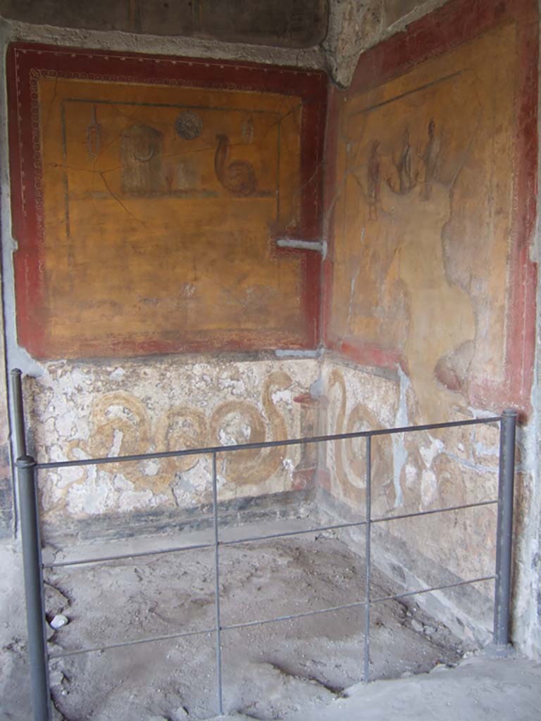 VI.16.7 Pompeii. May 2006. Room F, lararium in south-east corner of peristyle.  
According to Boyce, in the south-east corner is a shrine dedicated to the cult of the Egyptian deities.
On each wall a large yellow panel is marked off by a broad red border.
See Boyce G. K., 1937. Corpus of the Lararia of Pompeii. Rome: MAAR 14. (p.56, no.220).