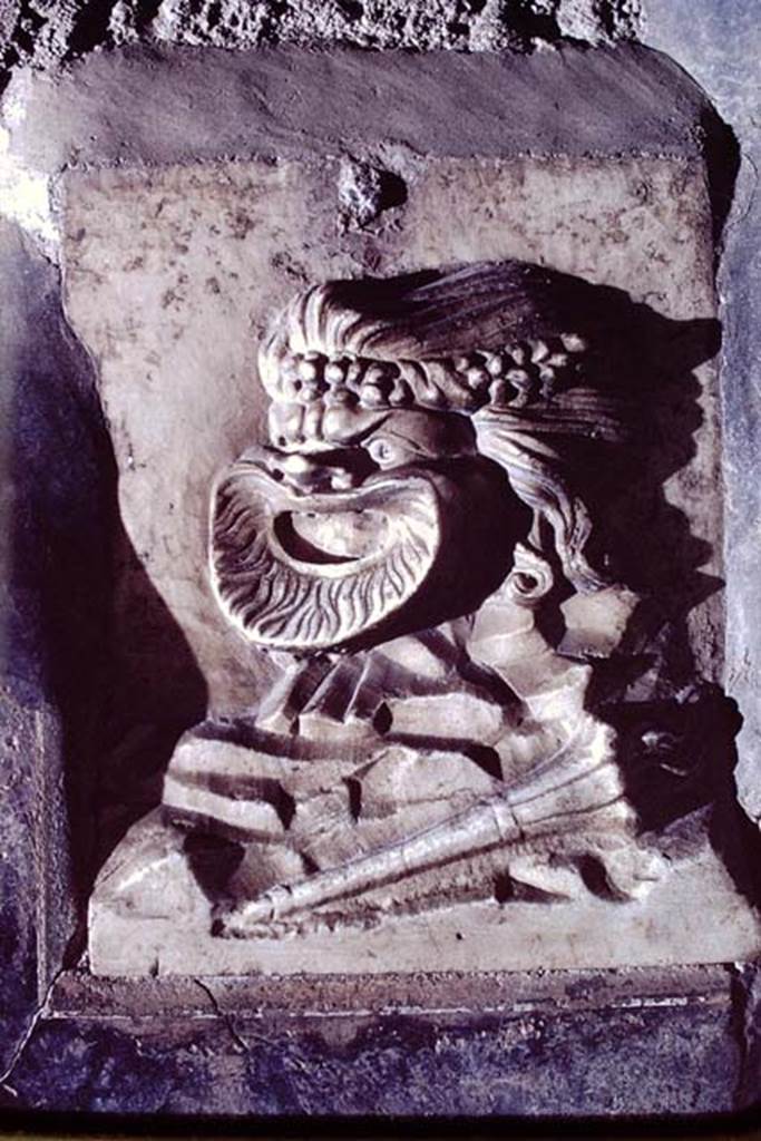 VI.16.7 Pompeii, 1968. 
Relief of mask, a fragment found embedded in the south wall. Photo by Stanley A. Jashemski.
Source: The Wilhelmina and Stanley A. Jashemski archive in the University of Maryland Library, Special Collections (See collection page) and made available under the Creative Commons Attribution-Non-Commercial License v.4. See Licence and use details.
J68f0234