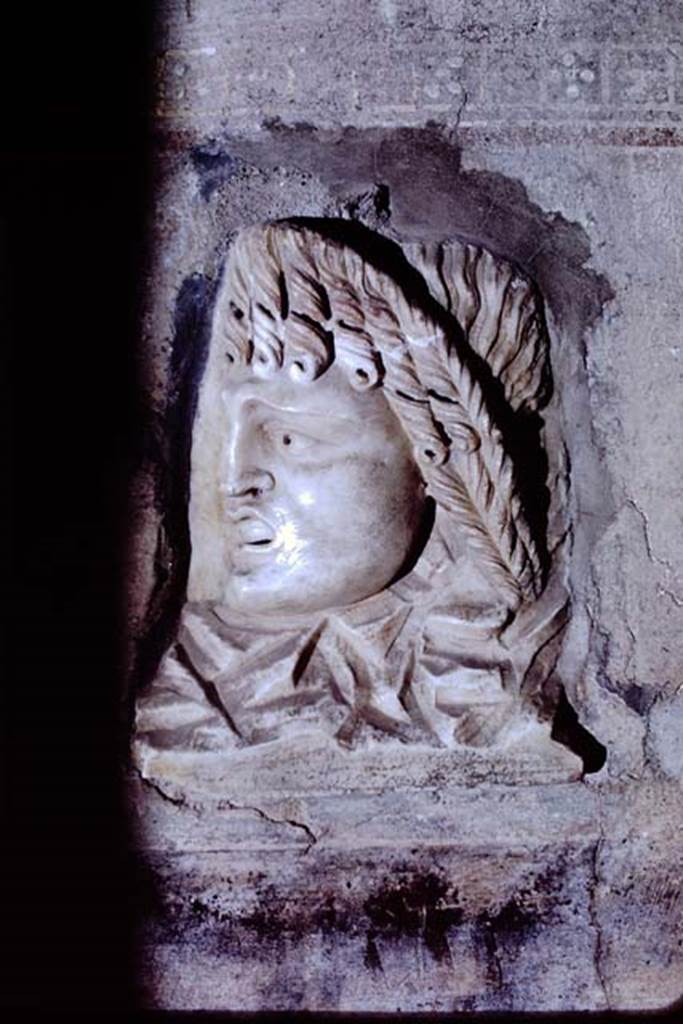 VI.16.7 Pompeii, 1968. Fragment of a relief with a mask, found embedded on the south side of the west wall, near south-west corner.   Photo by Stanley A. Jashemski.
Source: The Wilhelmina and Stanley A. Jashemski archive in the University of Maryland Library, Special Collections (See collection page) and made available under the Creative Commons Attribution-Non Commercial License v.4. See Licence and use details. J68f0233
