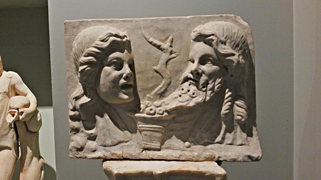VI.16.7 Pompeii. December 2019. Marble relief with two theatrical masks on a pilaster in peristyle garden.
From the exhibition “Pompei e Santorini”, Rome, 2019. Photo courtesy of Giuseppe Ciaramella.