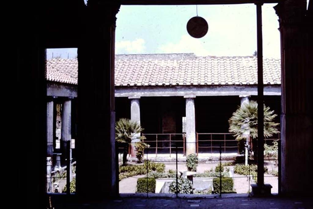 VI.16.7 Pompeii. 1964.  Looking east across west portico to peristyle, from room O.  Photo by Stanley A. Jashemski.
Source: The Wilhelmina and Stanley A. Jashemski archive in the University of Maryland Library, Special Collections (See collection page) and made available under the Creative Commons Attribution-Non Commercial License v.4. See Licence and use details.
J64f1873
