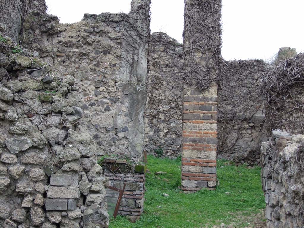 VI.16.10 Pompeii. December 2007. Looking west through atrium or corridor to rear of house.
According to NdS, on the south side of the corridor was a cubiculum C (left of photo).
The cubiculum had a floor of cocciopesto, white walls and a window in its west wall.
From the corridor through a wide doorway that formed a step one entered into the covered area E.
This was excavated on 10th May 1904.
The floor was beaten earth, and preserved on the walls were traces of rough plaster.
The east side consisted of four pillars, between the two central pillars was the entrance from the corridor.
The window from cubiculum C was between the two pillars on the south side.
The two on the north side formed a frame that formed one of the walls of a cupboard (armarium).
