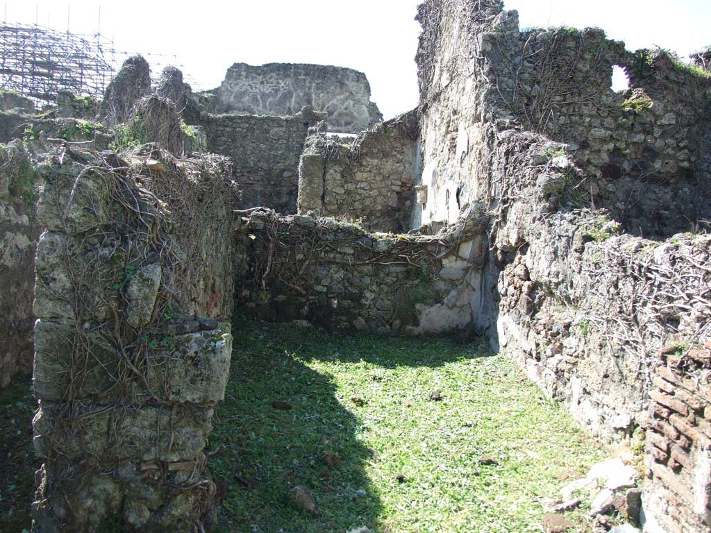 VI.16.12 Pompeii. March 2009. Looking west into rear-room on north-west side behind shop room.
According to NdS, the rear room had flooring of opus signinum, and the walls were of rough plaster.
The room received light from a window in the west wall, with wooden windowsill and jambs.