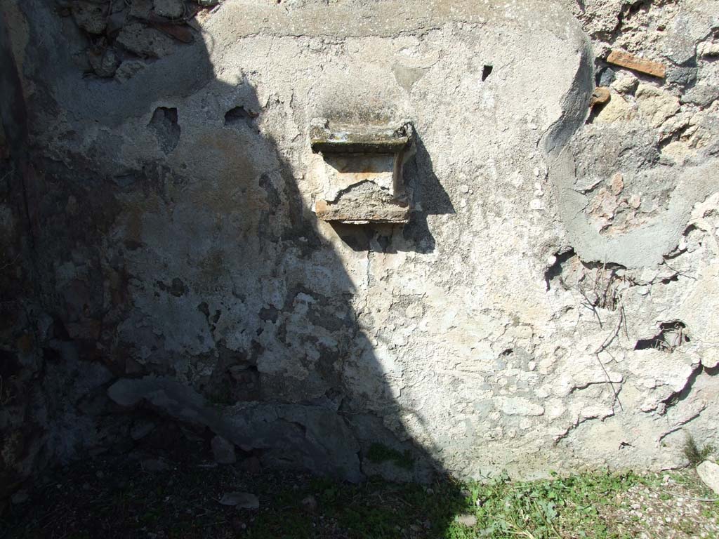 VI.16.12 Pompeii. March 2009. North wall with masonry altar projecting from wall. 
There used to be two painted serpents, one either side of the altar. 
A painted pine cone was on the wall above the altar.
See Warscher, T., 1925. Pompeji: Ein Führer durch die Ruinen. Berlin und Leipzig: de Gruyter. (p.102, abb 21).