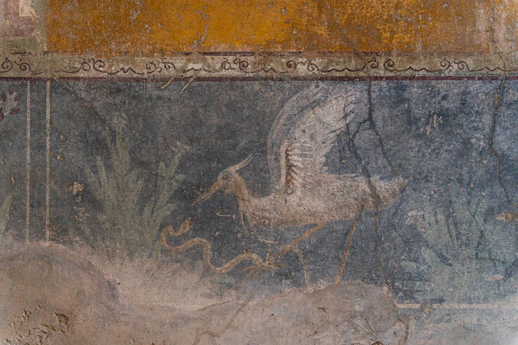 VI.16.15 Pompeii. January 2024. 
Room F, centre of zoccolo of lower west wall with painting of bird, serpent and plants. Photo courtesy of Johannes Eber.