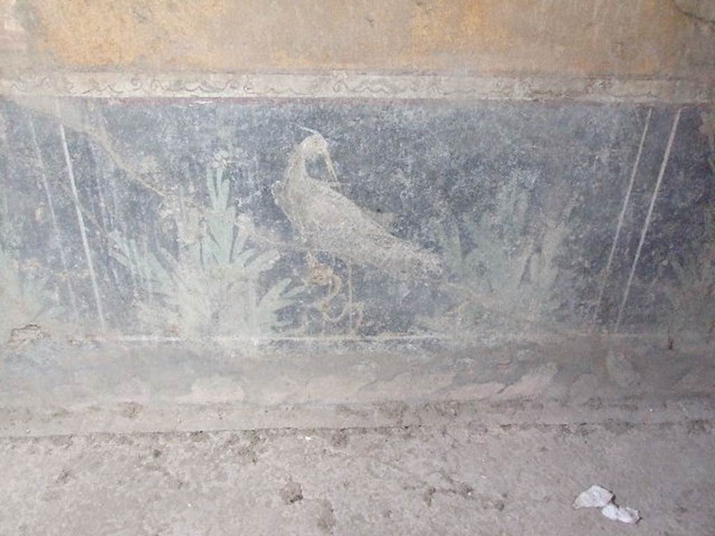 VI.16.15 Pompeii. December 2006. Centre of base of east wall of room F with detail of wall painting of bird and plants.