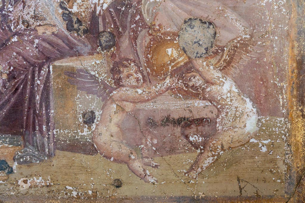 VI.16.15 Pompeii. January 2024. 
Room G, detail of Cupids playing with helmet of Mars, from central painting on north wall. Photo courtesy of Johannes Eber.