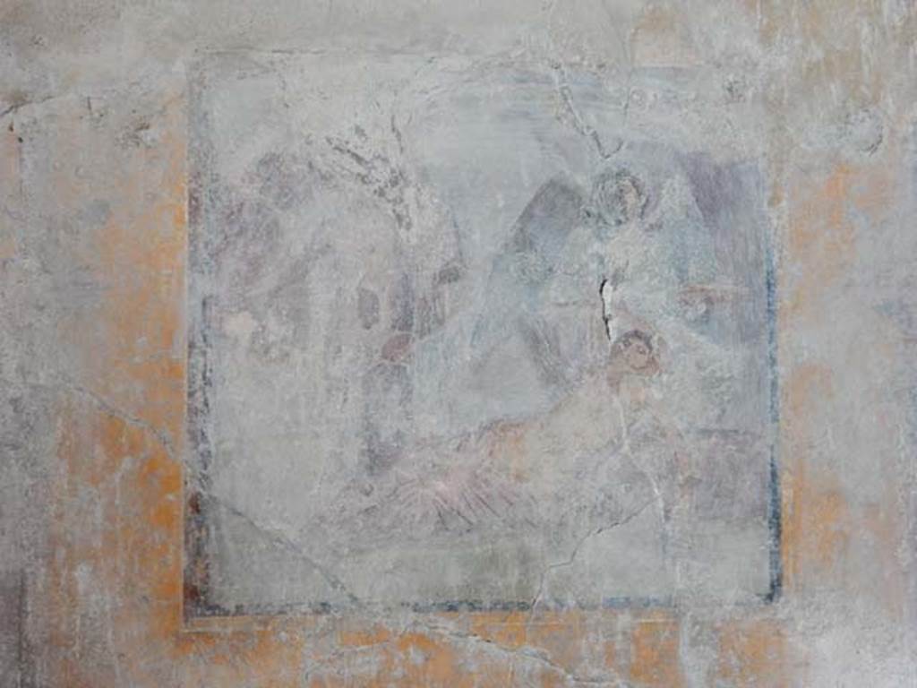 VI.16.15 Pompeii. May 2015.  
West wall of room G with central wall painting of the arrival of Dionysus on Naxos where Ariadne is sleeping. Photo courtesy of Buzz Ferebee.
Kuivalainen describes –
“A composition of at least six figures; the two on the right are in an arching cave-like space, marked with dark brown. In the foreground, a female reclining to the right, raises her right arm to the top of her head as if awakening; a pink cloak covers her legs. Behind her stands a figure with green wings, dressed in a green robe, holding branches in her right hand and a large patera in her left. On the left side of the picture stands a youth stretching his right arm to the left, with a red cloak covering his left shoulder; in his left hand he holds a thyrsus. Behind are members of the thiasus, perhaps with Silenus on the left.”
Kuivalainen comments –
“Another version of the same theme, but Bacchus now seems to be paying less attention to the awakening Ariadne.”
See Kuivalainen, I., 2021. The Portrayal of Pompeian Bacchus. Commentationes Humanarum Litterarum 140. Helsinki: Finnish Society of Sciences and Letters, (p.148, E10).