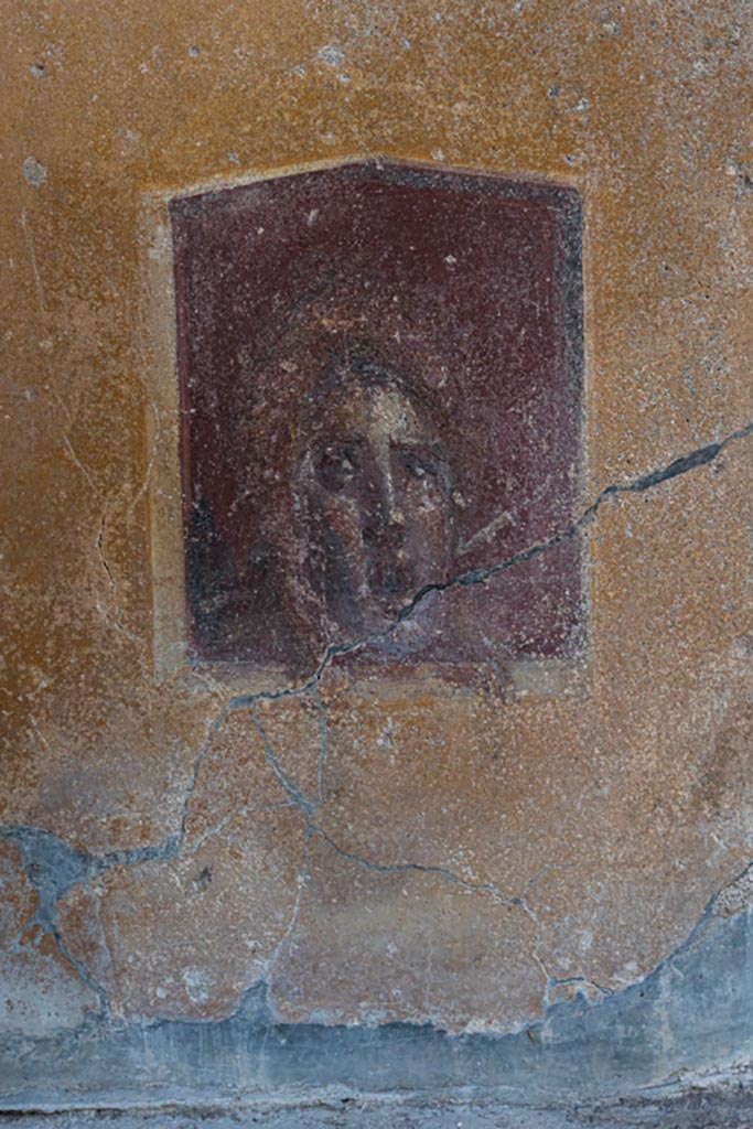 VI.16.15 Pompeii. January 2024.
Base of painted pilaster with mask or face on west side of atrium B. Photo courtesy of Johannes Eber.