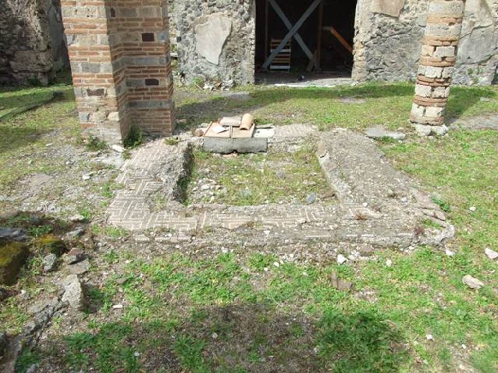 VI.16.27 Pompeii. March 2009. Room B, looking north across impluvium in atrium. According to NdS, the square shaped impluvium had its base covered with signinum with numerous pieces of marble randomly buried into it. The sides were covered with brick plaster and a wide border of cocciopesto with a lovely design of meander made with white tesserae.  
The atrium floor was of cocciopesto. See Notizie degli Scavi, 1908, (p.184)