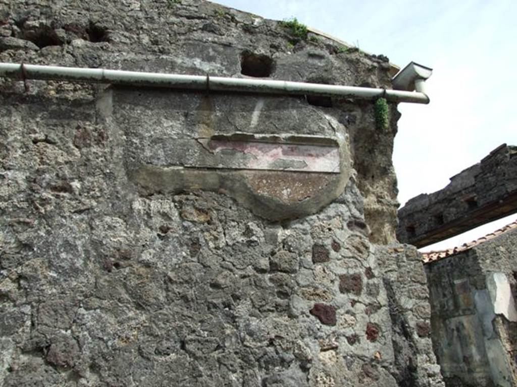 VI.16.27 Pompeii. March 2009.  Room F, remains of decoration and painted plaster on east wall above staircase.