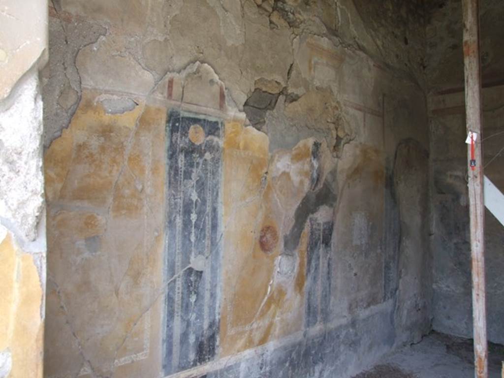 VI.16.27 Pompeii. March 2009. Room G, west wall of triclinium. According to NdS, the western wall had four panels, but the one on the right was missing. In the centre of each panel were - starting from the left,  a flying griffin, next was a flying swan in a medallion.
In the third panel was a picture (0.32m high x 0.31 wide) but very faded. Here could be seen a male figure sitting on the left, with his left arm resting on the back of a seat. His right arm held up towards the left. It could be Ganimede beckoning to the eagle who descends from above. On both sides of the entrance doorway was a panel, each one with a tragic mask in the middle. See Notizie degli Scavi, 1908 (p.187)