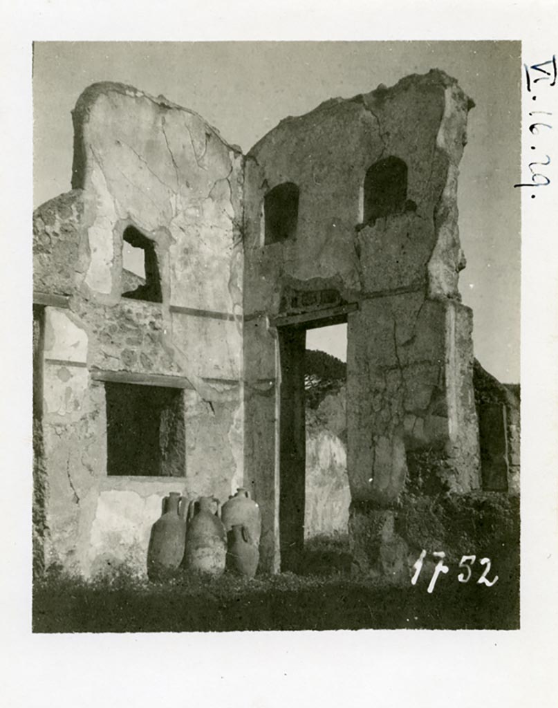 VI.16.29 Pompeii. Pre-1937-39. Looking north-east across atrium. 
Photo courtesy of American Academy in Rome, Photographic Archive. Warsher collection no. 1752.
On the left would have been the doorway to room G, oecus fenestratum.
In the south wall of room G would have been a window overlooking the atrium, and above that in the same wall was another small window.
In the east wall was a doorway into room H.
According to Giacobello, the doorway and wall on the east side of the atrium containing two niches collapsed following the 1980 earthquake.
Today, of the two arched niches only the one on the left has been partially conserved. 
They would have been a short distance away from each other and plastered inside in white stucco.
See Giacobello, F., 2008. Larari Pompeiani: Iconografia e culto dei Lari in ambito domestico. Milano: LED Edizioni. (p.243).