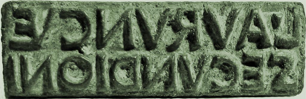 VI.16.32/33 Pompeii. 14th June 1904. Bronze sigillo or stamp of L. Aurunculeius Secundio. 
It reads L. AVRVNC(VL)E SECVNDIONI or (Produce of?) Lucius Aurunculeius Secundio.
Photographed at “A Day in Pompeii” exhibition at Melbourne Museum. September 2009.
SAP inventory number 55814. 
According to the Epigraphic Database Roma the SAP inventory number is 3318.
According to Della Corte, the family Aurunculei were not otherwise known in Pompeii. 
This Secundio may have been a freedman who moved to Pompeii after gaining his liberty.
One of the two seal/signets found, indicated to Della Corte the name of the house host.
It read on the base –
L.  AVRVNCVLEI
  SECVNDIONIS 
And on the bezel        L. A. S                
The other seal/signet only showed the initials A. B….. L…..  
See Della Corte, M., 1965. Case ed Abitanti di Pompei. Napoli: Fausto Fiorentino. (Pages 71-2, Item 95, and S8 and S10).