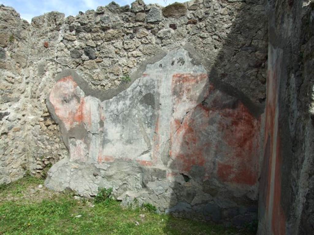 VI.16.32 Pompeii. March 2009. Room E, east wall with central panel  (height 1.10m width 0.76m) . According to NdS, the central panel showed a painting of a sacred grove with a herm of Priapus painted in red. On the right was a high pilaster, on top of which was a large rounded vase. Near the base of the pilaster was a red statue of Minerva. To the left of the painting, were two women approaching an altar placed before Priapus, and of these that to the right carried some offerings. In front of the sacred enclosure was either a river or lake, with a bridge. At the left end of the bridge were two goats drinking. There was also another woman followed by a boy and a girl. See Notizie degli Scavi di Antichità, 1908, (p296-7).
