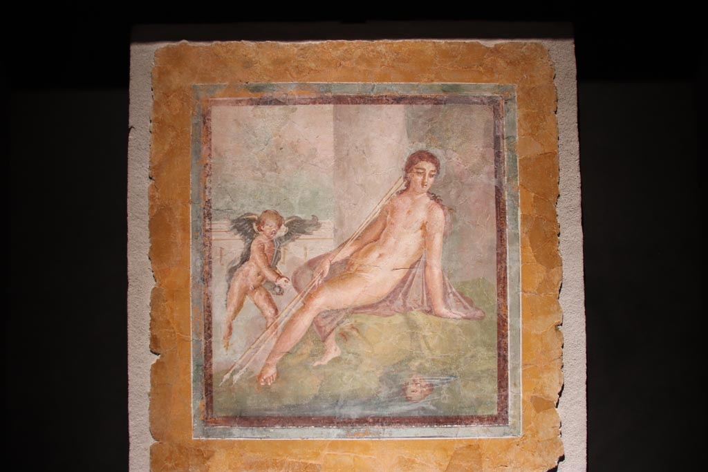 Insula Occidentalis, Pompeii. October 2022. 
Narcissus looking at his reflection in the water with a cherub at his side. Photo courtesy of Klaus Heese. 
Photographed in an exhibition in the Palaestra 2022.
The information card at the exhibition only said –
“Narcissus looking at his reflection in the water and a cherub. Fresco, 1st century AD, Pompeii, Insula Occidentalis.”  
According to Mastroroberto –
This painting of Narcissus (76 x 73 cms) may have the inventory number 17739.
See Pompei - Picta Fragmenta, exhibition catalogue 1997-98 curated by P.G. Guzzo, (p.122, no.74).