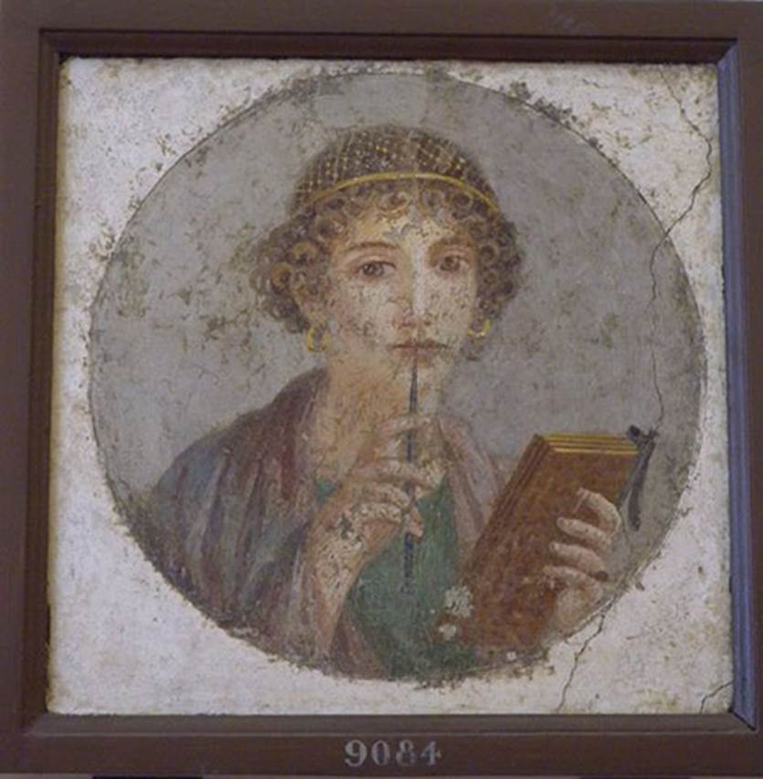 Pompeii Insula Occidentalis. Found 17th May 1760. Sappho or young woman with tablet and stylus, found beneath the Cuomo property.
Now in Naples Archaeological Museum. Inventory number 9084.
According to Grasso, this medallion found in June 1760 is one of the most noted frescoes of the Naples Museum.
See Bragantini, I & Sampaolo, V (eds). 2009. La Pittura Pompeiana, (Electa), (p.526-7)
According to AdE, it was found with the medallion showing the youth with a scroll (9085).
See Antichità di Ercolano: Tomo Terzo: Le Pitture 3, 1762, p. 237, Tav. 46.