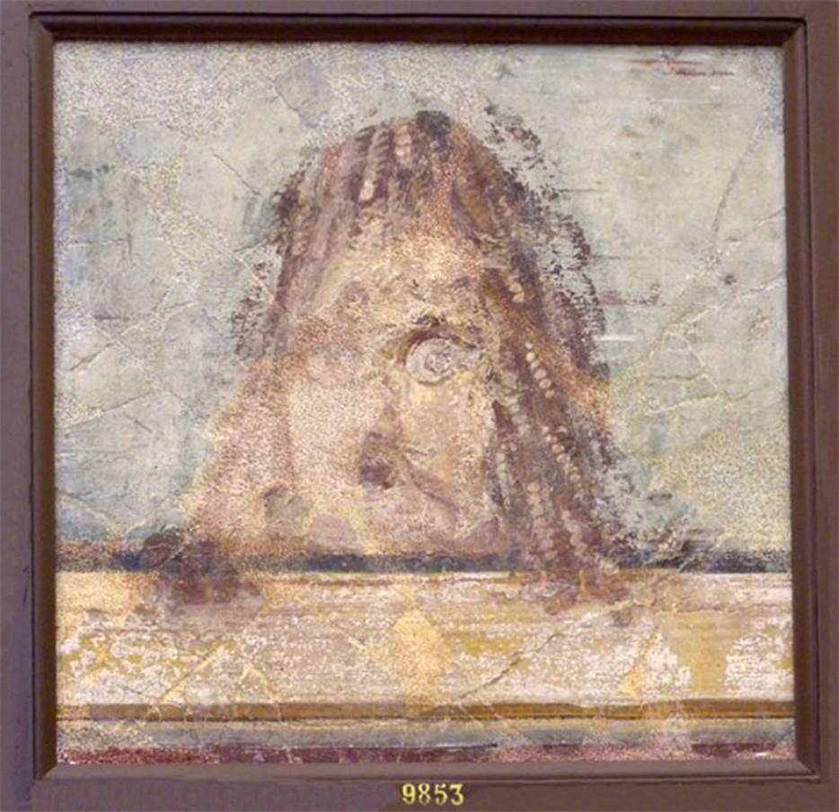 VI.17.9-10 Pompeii. Found 20-29 October 1763 or 2nd July 1763. 
Now in Naples Archaeological Museum. Inventory number 9853.
Mask found at the same time as the other two, but the colour was faded and the face was ruined by a pointed instrument.