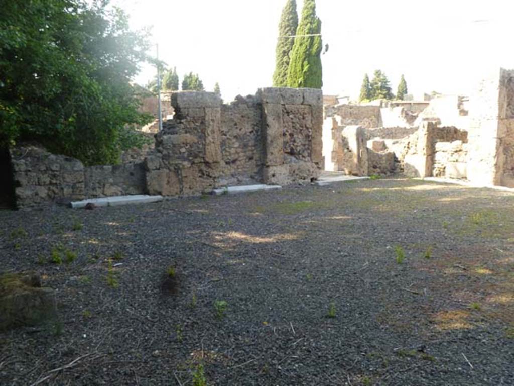 VI.17.17 Pompeii. May 2011. Looking along north side of atrium towards the north-east corner. Although Fiorelli stated there were only rooms on one side of the atrium, see below, there are definitely three thresholds on the north side (as well as three rooms with thresholds on the south side). The doorways on the north side (now blocked) were ancient. 
Fiorelli -“Esse avevano due ingressi separati sulla strada e due botteghe, stando in relazione tra loro per gli atrii, entrambi tuscanici, e ciascuno con tre cubicoli da un solo lato”.
(translation -They had two separate entrances on the roadway and two shops, linked to the atriums, both atriums were Tuscanic, and each with three cubicula only on one side.)