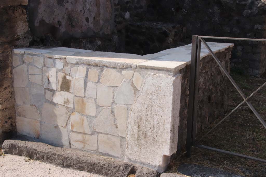 VI.17.31 Pompeii. September 2021. 
Looking south-west to sales podium/counter bench faced with marble slabs. Photo courtesy of Klaus Heese.