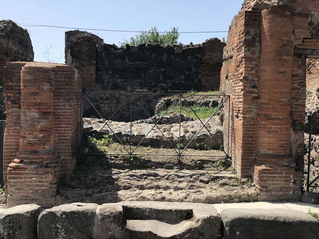 VI.17.36 Pompeii. April 2019. Looking west past step cut in kerb to entrance doorway with a brick half round column on each side. 
Photo courtesy of Rick Bauer.
According to Breton – 
“This house was built on the ancient city ramparts and had many floors on terraces leading down to the sea, it appears to have been very large but despite the excavations made in 1808 and 1817, it had never been fully excavated. Of the remains, much of it was in a large state of degradation. 
This house showed many remarkable peculiarities, having two doors onto the same street opening directly and without a prothyron onto two rooms bigger than an ordinary vestibule. The large Corinthian atrium did not have a width of less than 28.9m: its portico was formed of arches and columns.
The portico of the atrium, as well as several rooms, was paved with black and white mosaics. 
A fountain that decorated this area was not placed in the axis of the atrium, but a little to the side, in order to face the door of main vestibule.
In one of the rooms that surrounded the atrium was another small fountain. Under this house was the most beautiful cellar yet found at Pompeii.
See Breton, Ernest. (1855). Pompeia, decrite et dessine: 2nd ed. Paris: Baudry, (p.219-220)