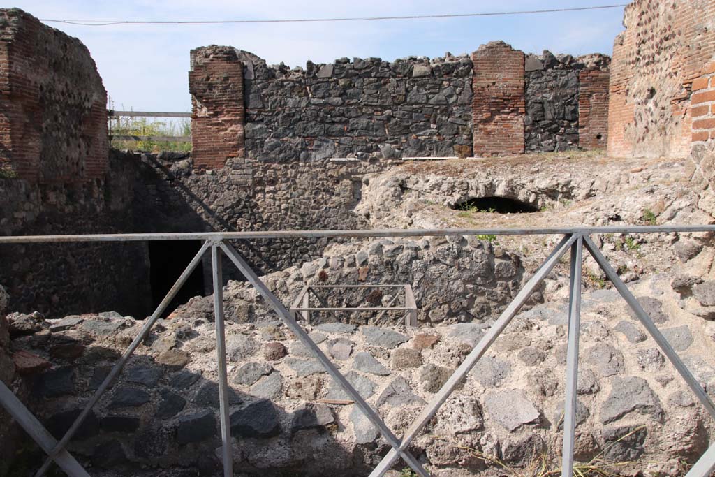 VI.17.36 Pompeii. September 2021. 
Looking west at the different levels. The atrium floor is no longer there but would have been above these lower rooms.
On its west side, the atrium would have had three doorways, one larger central and two side doorways leading to the peristyle area.
Photo courtesy of Klaus Heese.