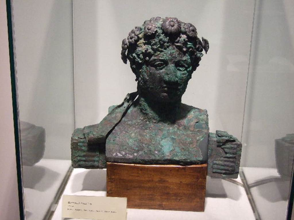 VI.17.42 Pompeii. December 2006. Bronze bust from Insula Occidentalis, (prov; Ins. Occ, Casa di Fabio Rufo). 
Photographed in Boscoreale Antiquarium and Museum.