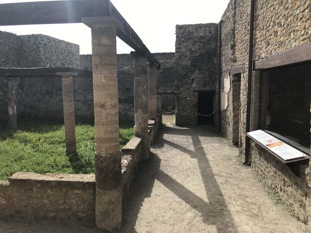 VII.1.47/25 Pompeii. April 2019. Looking south through doorway in south wall of peristyle 31.
Looking south across walled peristyle garden 19 from doorway/steps from peristyle 31 in VII.1.25. 
Photo courtesy of Rick Bauer.