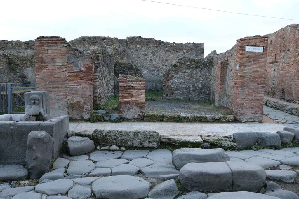 VII.1.33 Pompeii, on right of fountain, and VII.1.34 Pompeii, centre right. December 2018. 
Looking west towards entrance doorways. Photo courtesy of Aude Durand.