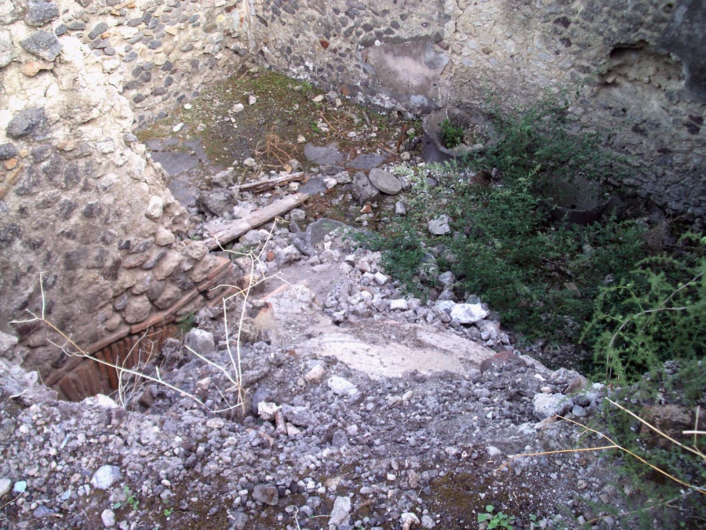 VII.1.36 Pompeii. August 2008. 
Looking south-east across top of rear of oven towards room in south-west corner with mills. Photo courtesy of Jared Benton.