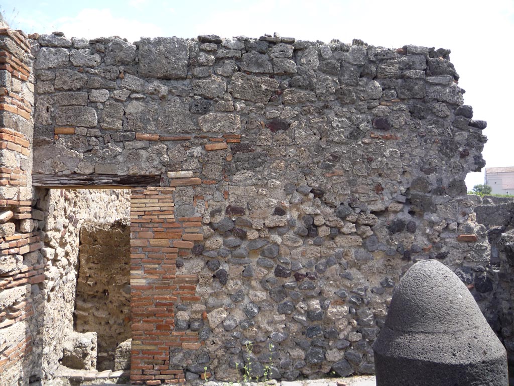 VII.1.36 Pompeii. October 2009. 
East wall of room in south-east corner, with doorway to latrine, on left. Photo courtesy of Jared Benton.