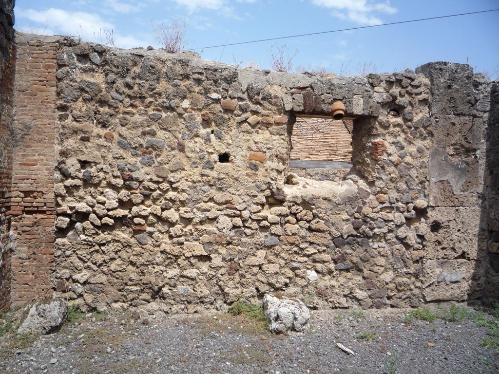 VII.1.36 Pompeii. October 2009. North wall with window onto Via degli Augustali, in room on east side of entrance corridor.
Photo courtesy of Jared Benton.