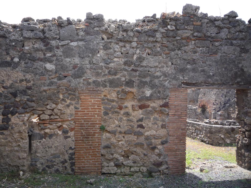 VII.1.36 Pompeii. October 2009. South wall of room on east side of entrance corridor, with doorway to atrium converted to bakery. 
Photo courtesy of Jared Benton.