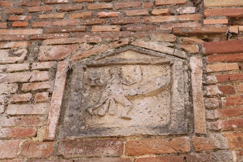 VII.1.36 Pompeii. December 2018. Detail of ithyphallic plaque. Photo courtesy of Aude Durand.
