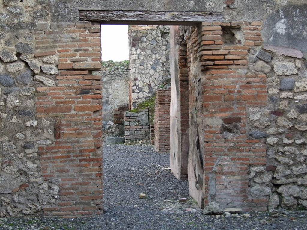 VII.1.37 Pompeii. December 2006. Doorway in south wall of shop, looking into bakery at VII.1.36.