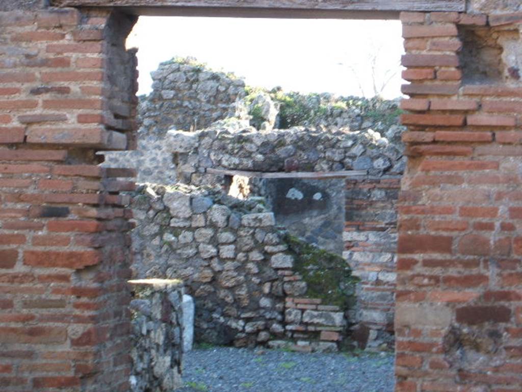 VII.1.37 Pompeii. December 2004. Looking south through doorway to bakery at VII.1.36.